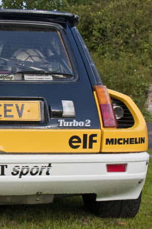 Vintage Renault 5 Turbo Parked At A Racing Event Wallpaper