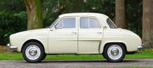 Vintage Renault Dauphine Standing In The Spotlight Wallpaper