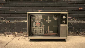 Vintage T V Against Brick Wall Wallpaper