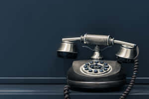 Vintage Telephoneon Desk Wallpaper