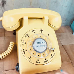 Vintage Yellow Rotary Phone Aesthetic.jpg Wallpaper