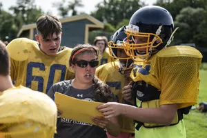 Visionary Football Coach Strategizing On Field Wallpaper