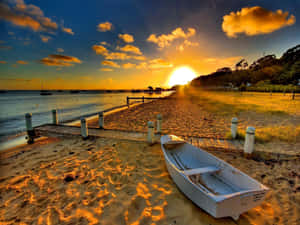 Visit The Beach And Witness A Beautiful Sunset Wallpaper