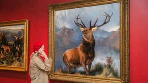 Visitor Admiring Stag Paintingat Art Gallery Wallpaper