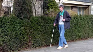 Visually Impaired Person Using White Cane Wallpaper