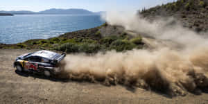 W R C Rally Car Dust Trail Seaside Track.jpg Wallpaper