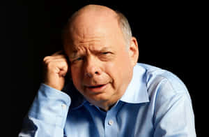 Wallace Shawn Posing In A Studio Wallpaper