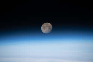 Waning Gibbous Moon Over Earth Horizon Wallpaper