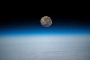 Waning Gibbous Moon Over Earth Horizon Wallpaper