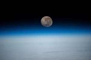 Waning Gibbous Moon Over Earth Horizon Wallpaper
