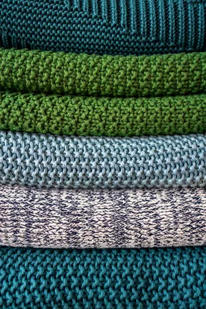Warm And Cozy Green And Blue Knitted Sweaters Wallpaper