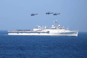 Warship With Hovering Helicopters Wallpaper