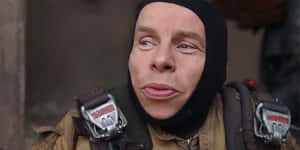 Warwick Davis Posing For A Professional Photoshoot Wallpaper
