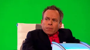 Warwick Davis Posing With His Hands Folded Wallpaper