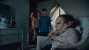 Warwick Davis Smiling At A Public Appearance Wallpaper