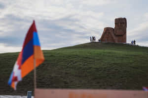 We Are Our Mountains Monument With Flag Wallpaper