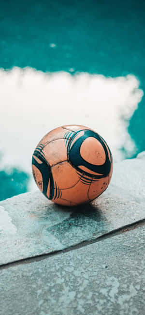 Weathered Soccer Ball Poolside Aesthetic.jpg Wallpaper