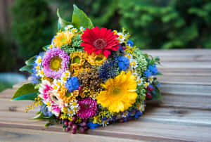 Wedding Bouquet: Elegant Bride Holding A Beautiful Floral Arrangement Wallpaper