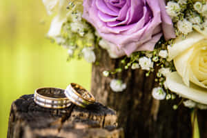 Wedding Ring On Wood With Flowers Wallpaper