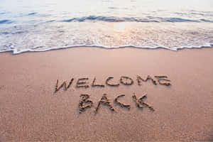 Welcome Back Beach Sand Writing Wallpaper