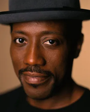 Wesley Snipes Smiling In A Suave Attire Wallpaper
