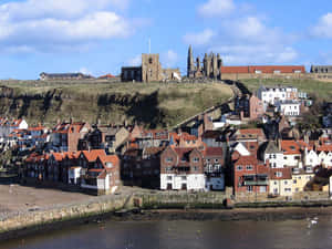 Whitby Abbey Overlooking Houses Wallpaper