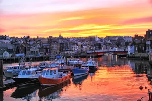 Whitby's Majestic Sunset Over The Harbor Wallpaper