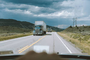 White Box Trucks Crossing Road Wallpaper