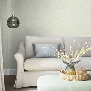 White Couch And Table Against A Wall With A Subtle Design Wallpaper