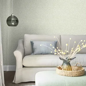 White Couch And Table Against A Wall With A Subtle Design Wallpaper