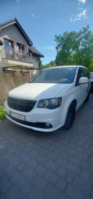 White Dodge Grand Caravan Residential Driveway Wallpaper