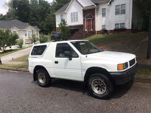 White Isuzu Amigo Suburban Setting Wallpaper