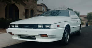 White Isuzu Impulse Parked Residential Area Wallpaper