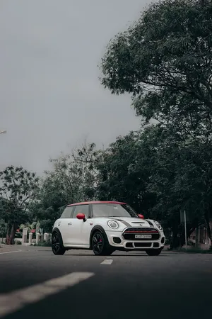 White Mini Cooper S E Parked Outdoors Wallpaper