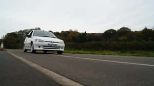 White Peugeot106 On Road Wallpaper