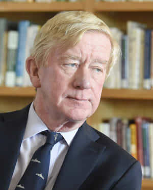 William Weld Against Book Shelves Wallpaper