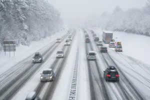 Winter Adventure: A Car Driving On A Snowy Road Wallpaper