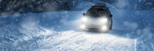 Winter Driving In Snowy Mountain Road Wallpaper