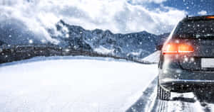 Winter Driving On Snowy Mountain Road Wallpaper