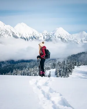 Winter Hiking Adventure In Snow-covered Mountains Wallpaper