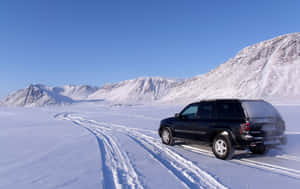 Winter Road Trip: Snowy Drive Through Scenic Mountain Terrain Wallpaper