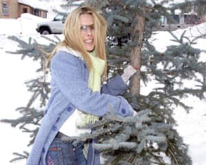 Winter Smile Behind Pine Tree Wallpaper