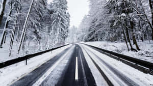 Winter Wonderland - A Snow-covered Icy Road Wallpaper