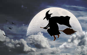 Witch Riding A Magical Broom At Night Wallpaper