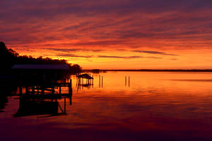 Witness The Majesty Of The Sea At Sunset Wallpaper