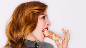 Woman Biting Into Pastry Wallpaper