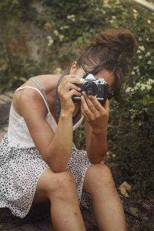 Woman Capturing The Beauty Of Nature. Wallpaper