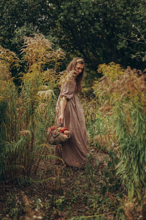 Woman Carrying Rustic Fall Apples Wallpaper