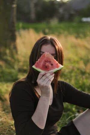 Woman_ Eating_ Watermelon_ Outdoors Wallpaper