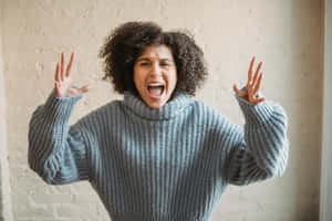 Woman Expressing Anger In Sweater Wallpaper